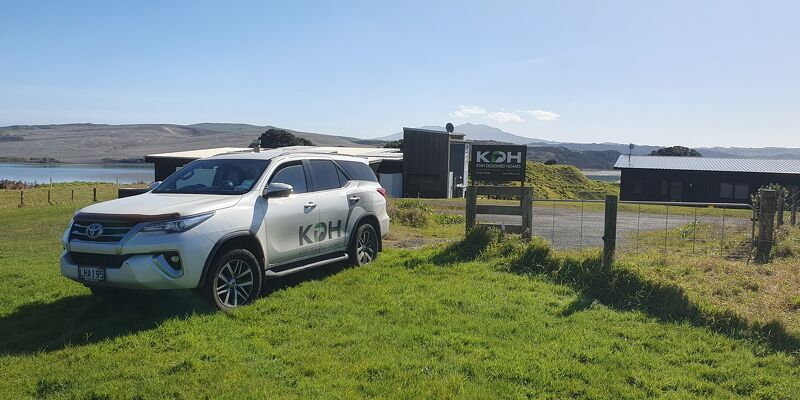 Image of Kiwi Transportable home staff doing a site survey for a transportable home on the coast in the Waikato